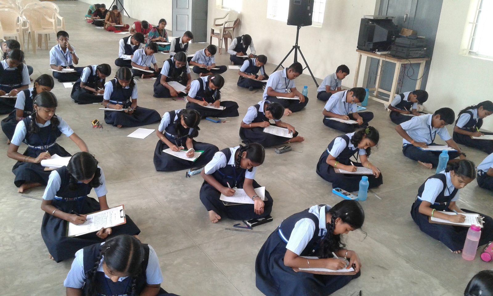 Students writing a competition in the hall
