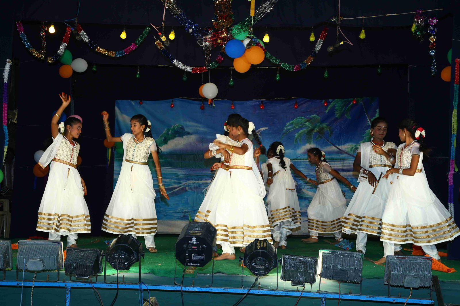 Girls performing a dance in white costumes
